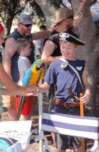 Pirate boy meets pirate parrot (macaw).