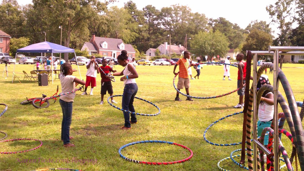 The children in the big hoop are about to figure out it won't hoop two people that way.
