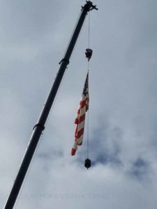 American flag flying from a construction crane.